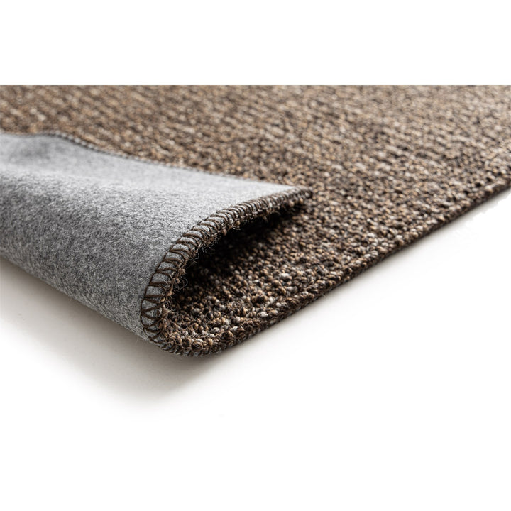 Dune Boucle brown textured rug, corner folded back to show the soft felt backing | The Rugs