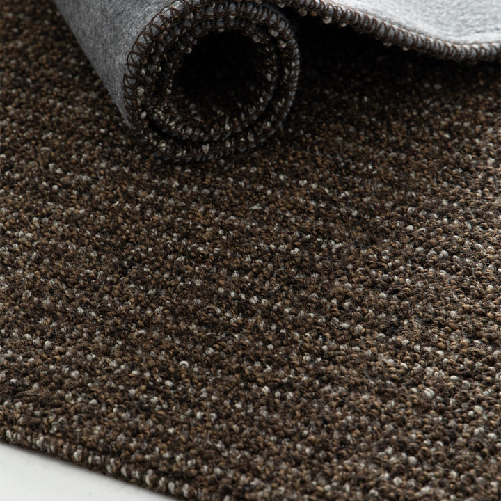 Dune Boucle brown textured rug, rolled up | The Rugs