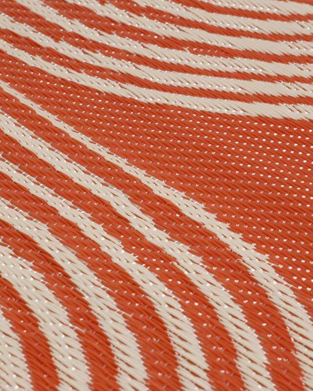 Close-up of Urban Outdoor Rug in terra and beige geometric pattern, mold and moisture resistant design.