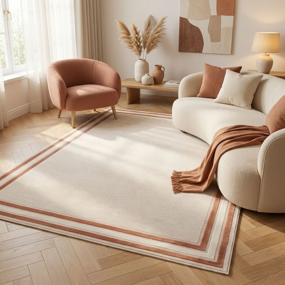 Living room with a beige sofa, brown armchair, and decorative rug.