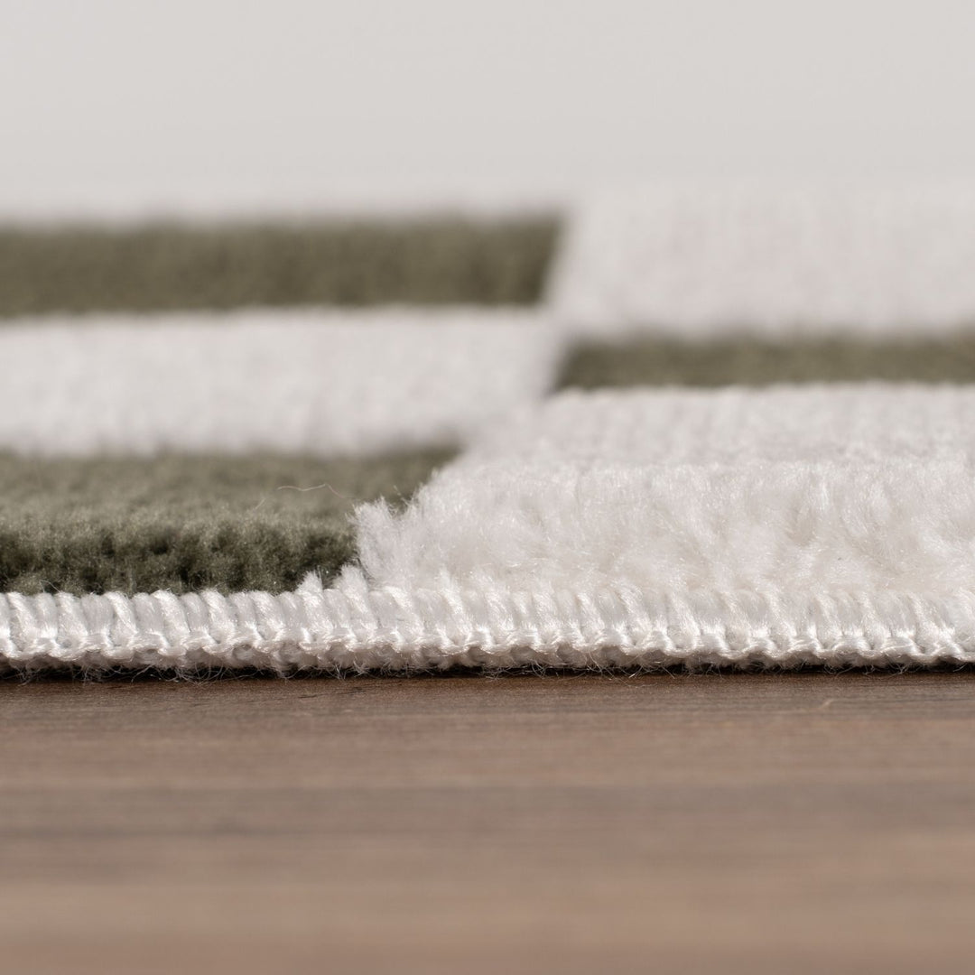 Close-up of a textured rug with a neutral color palette on a wooden floor.