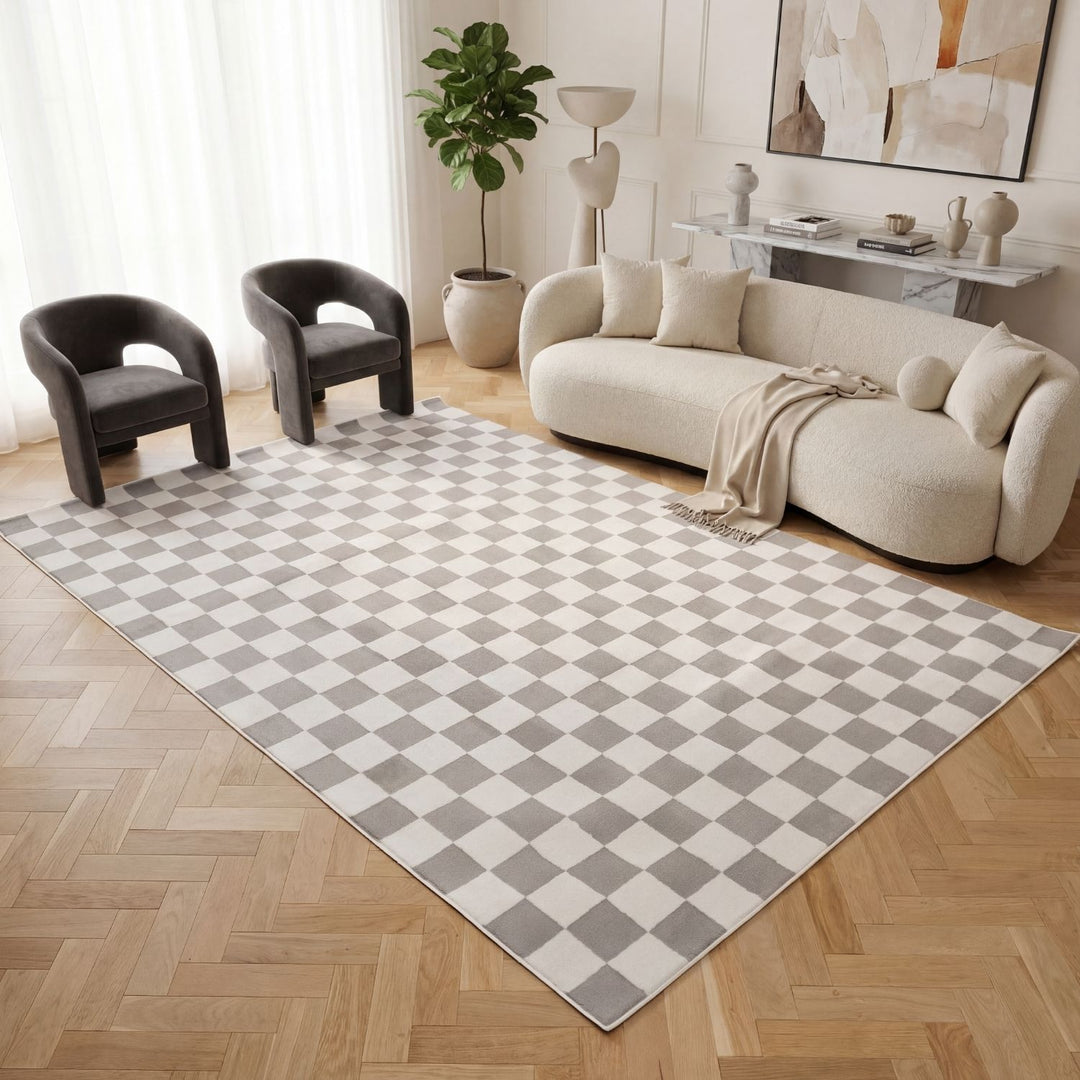 Living room with a checkered rug, beige sofa, and modern decor.