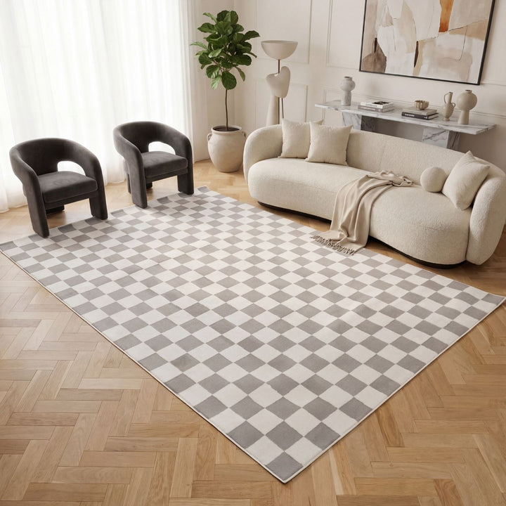 Living room with a checkered rug, beige sofa, and modern decor.