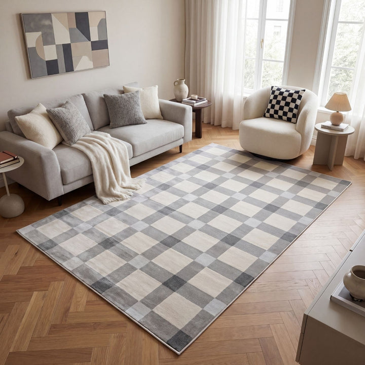 Living room with a checkered rug, sofa, and armchair.