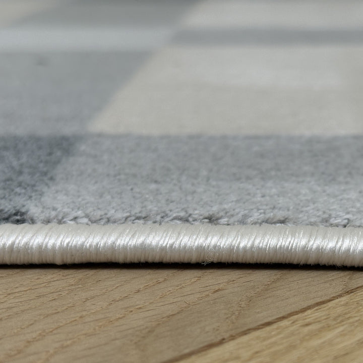 Close-up of a textured rug on a wooden floor