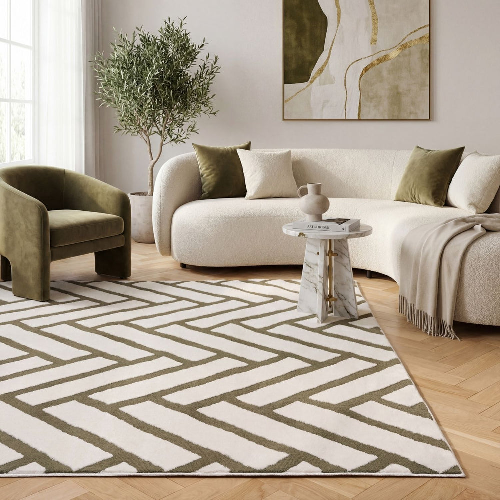 Modern living room with a patterned rug, sofa, and armchair.