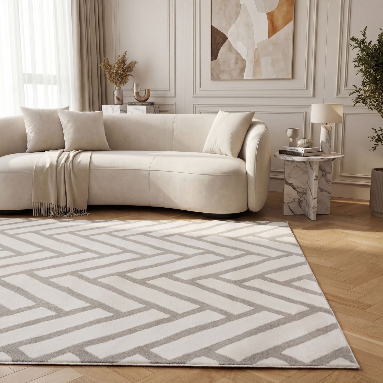 Living room with a beige sectional sofa, geometric patterned rug, and abstract art on the wall.