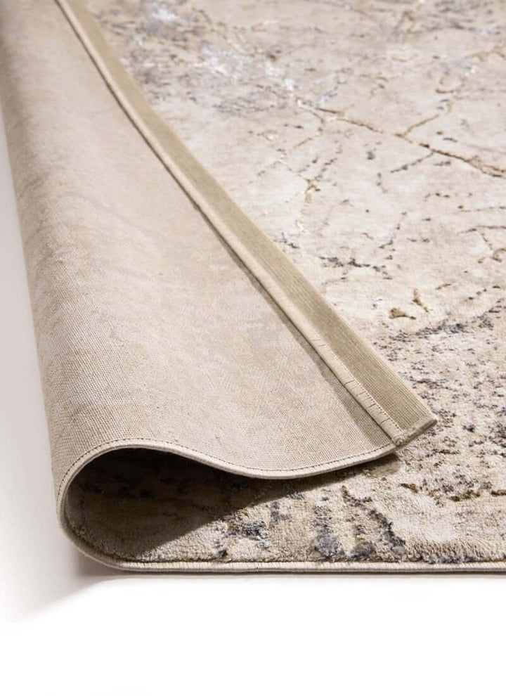 Abstract geometric rug in neutral tones, rolled up to show texture and design for modern eco-conscious spaces.