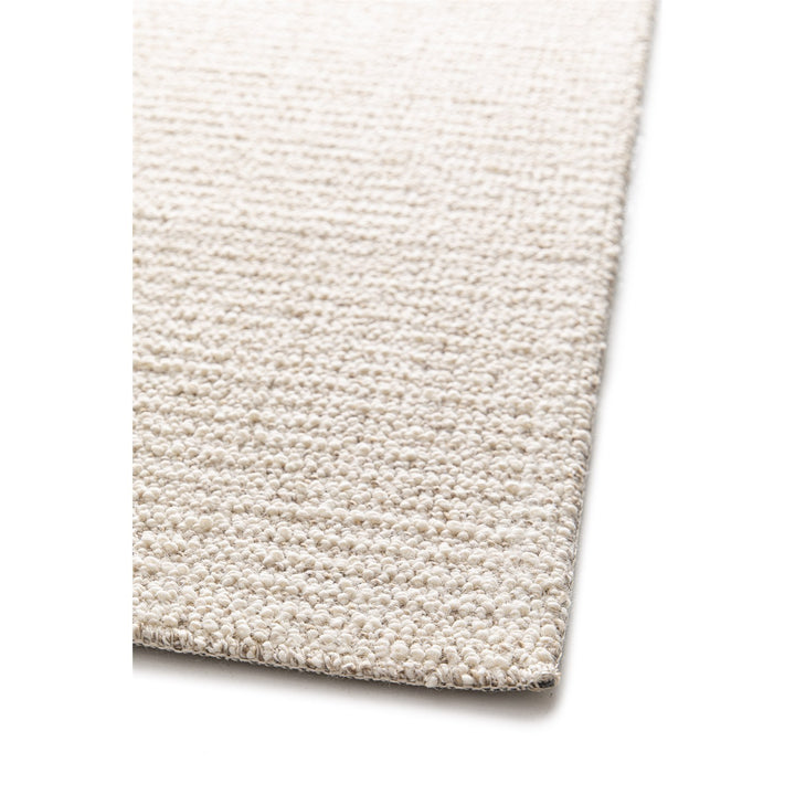 Dune Boucle cream textured rug, close-up of the bound edge | The Rugs
