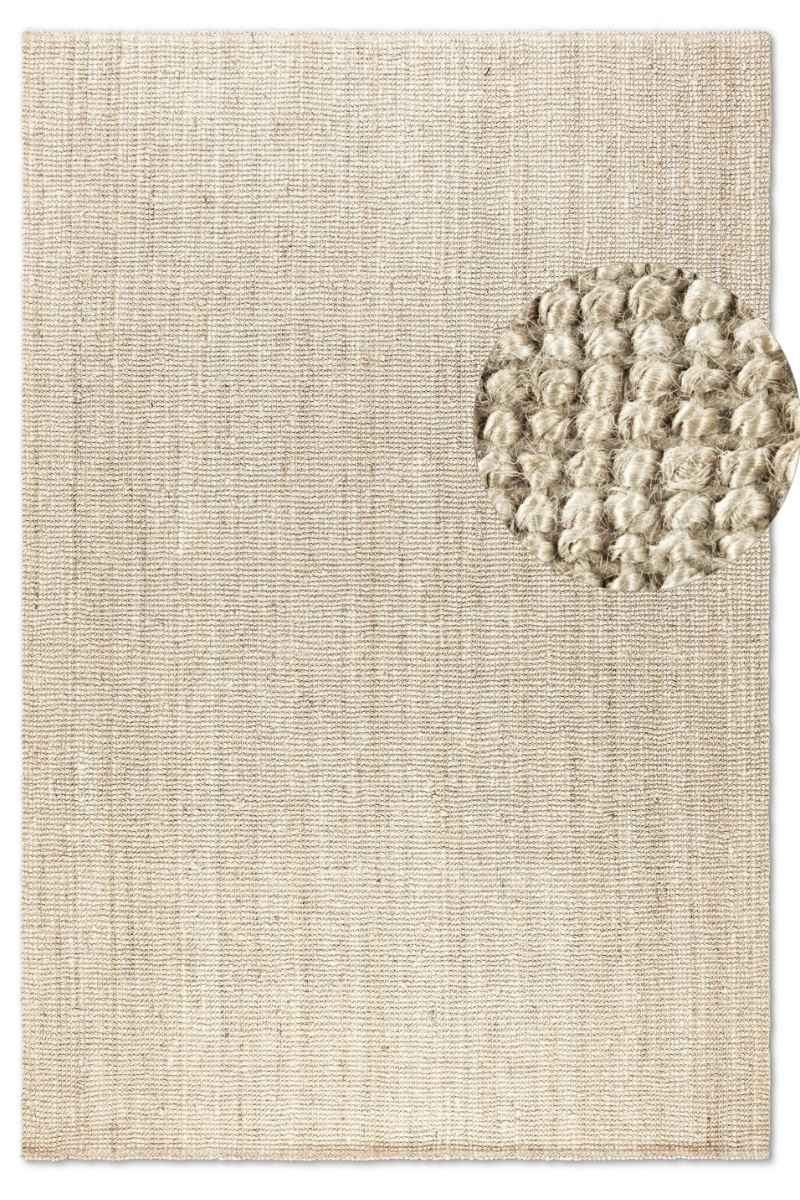 Textured beige rug with a circular pattern on a plain background