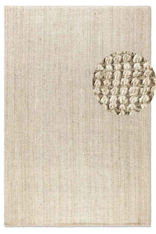Textured beige rug with a circular pattern on a plain background