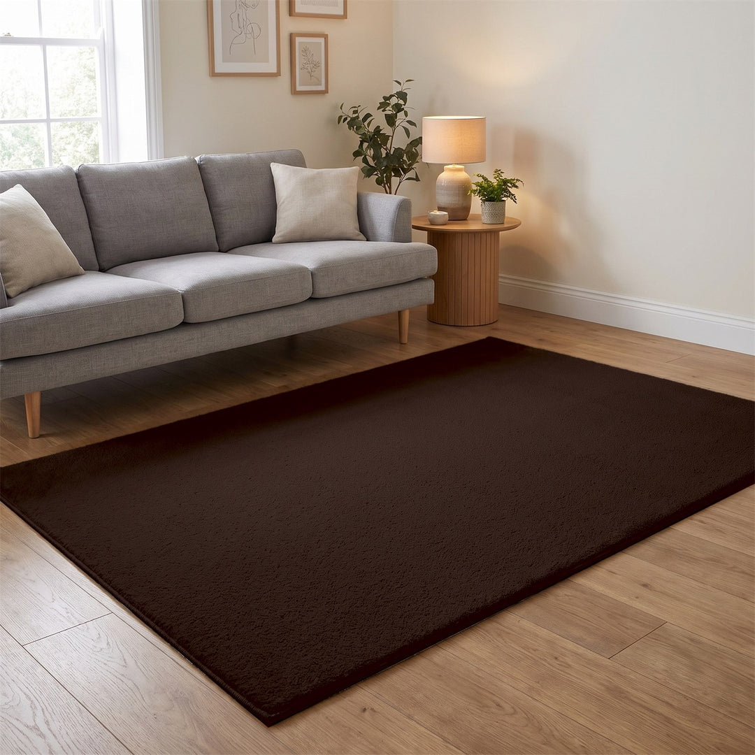 Washmellow dark brown washable rug in a living room with a grey sofa and oak floor | The Rugs