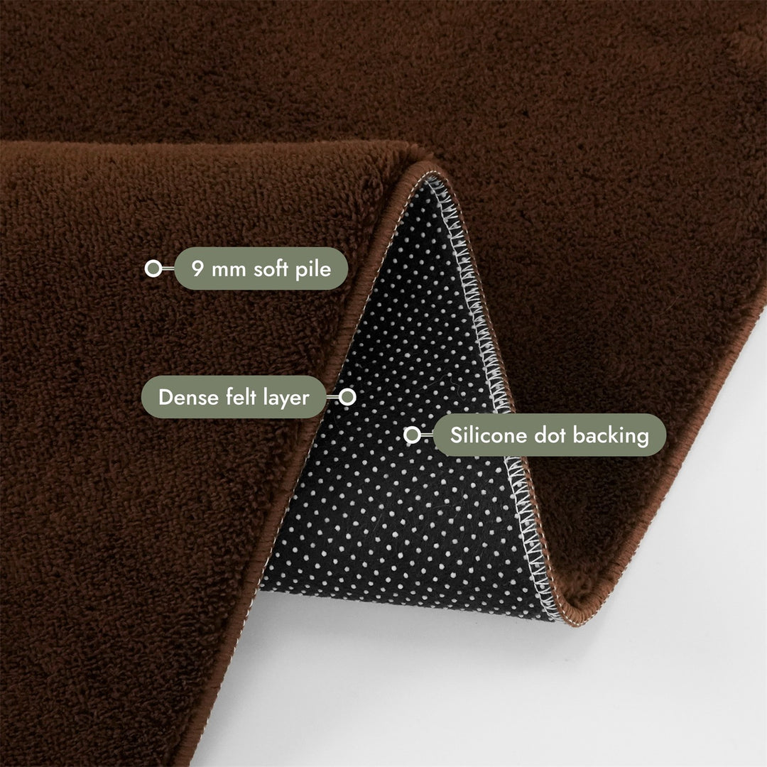 Washmellow dark brown washable rug, folded corner showing the pile, felt layer and backing | The Rugs
