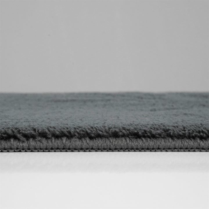 Washmellow dark grey washable rug, side view of the low pile and edge at floor level | The Rugs
