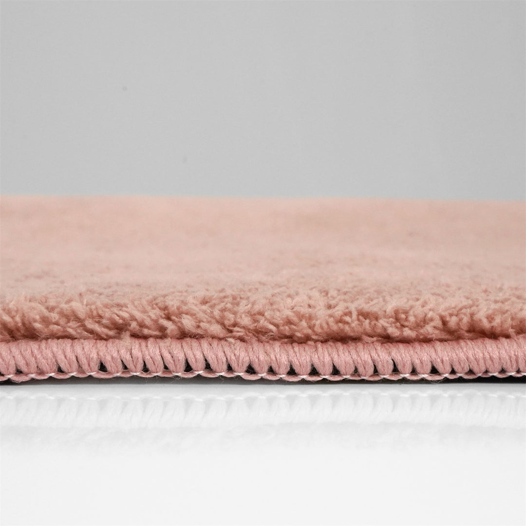 Washmellow dark pink washable rug, side view of the low pile and edge at floor level | The Rugs
