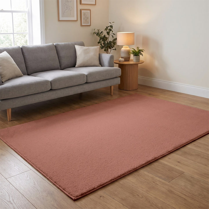 Washmellow dark pink washable rug in a living room with a grey sofa and oak floor | The Rugs