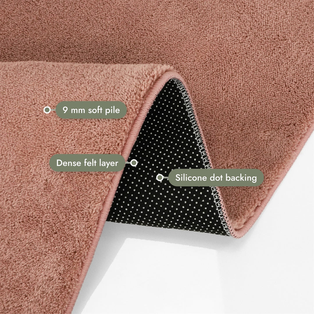 Washmellow dark pink washable rug, folded corner showing the pile, felt layer and backing | The Rugs