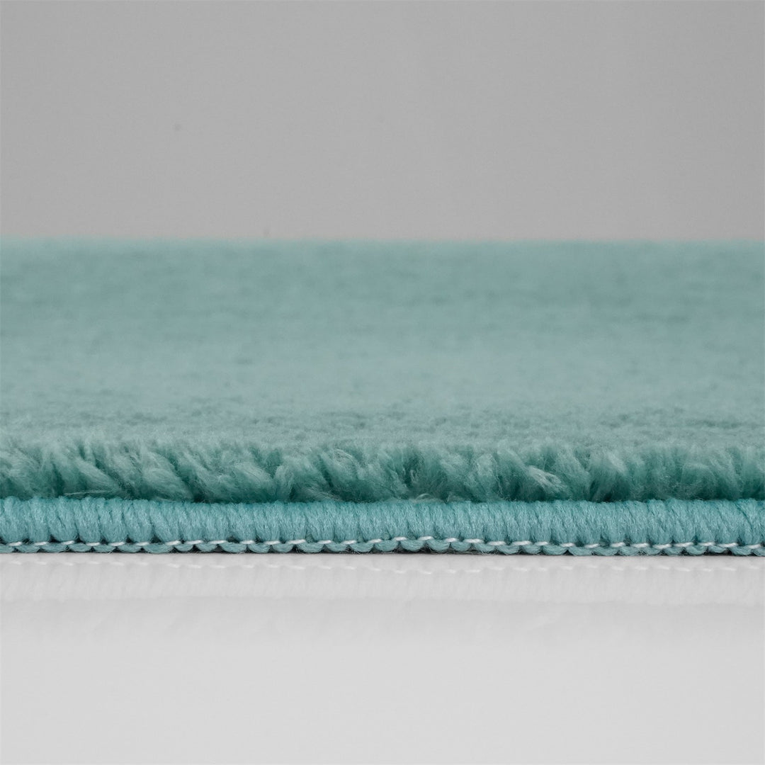 Washmellow duck egg blue washable rug, side view of the low pile and edge at floor level | The Rugs