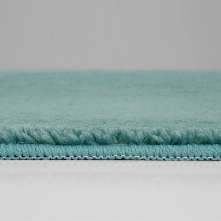 Washmellow duck egg blue washable rug, side view of the low pile and edge at floor level | The Rugs