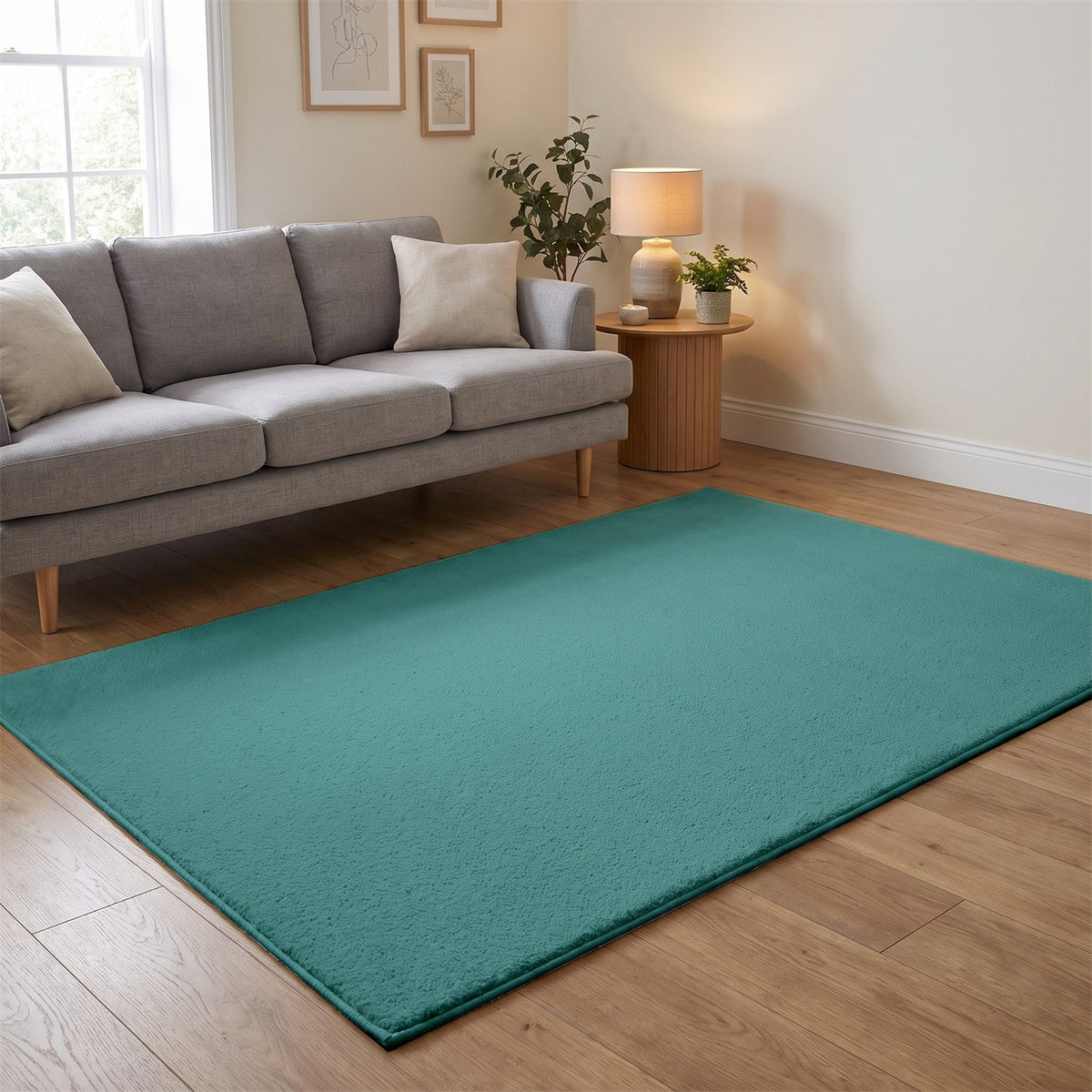 Washmellow duck egg blue washable rug in a living room with a grey sofa and oak floor | The Rugs