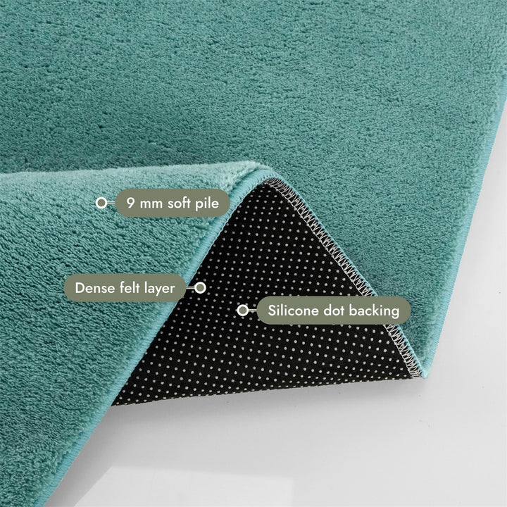 Washmellow duck egg blue washable rug, folded corner showing the pile, felt layer and backing | The Rugs