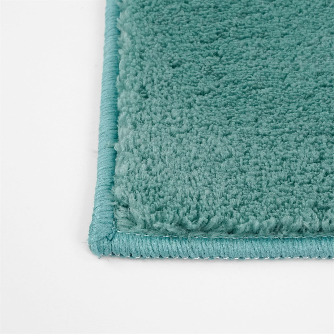 Washmellow duck egg blue washable rug, close-up of the corner and bound edge | The Rugs