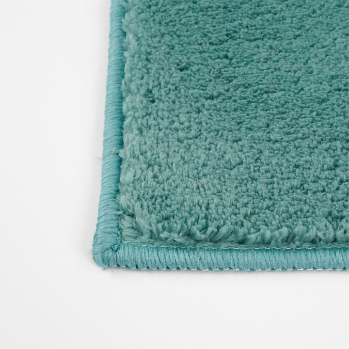 Washmellow duck egg blue washable rug, close-up of the corner and bound edge | The Rugs