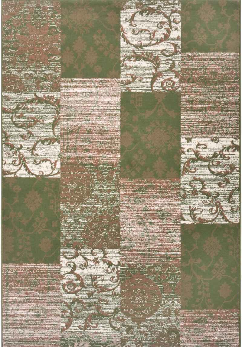 A geometric patchwork style rug with blocks of yellow, green, and grey colors, featuring a floral and abstract designs.