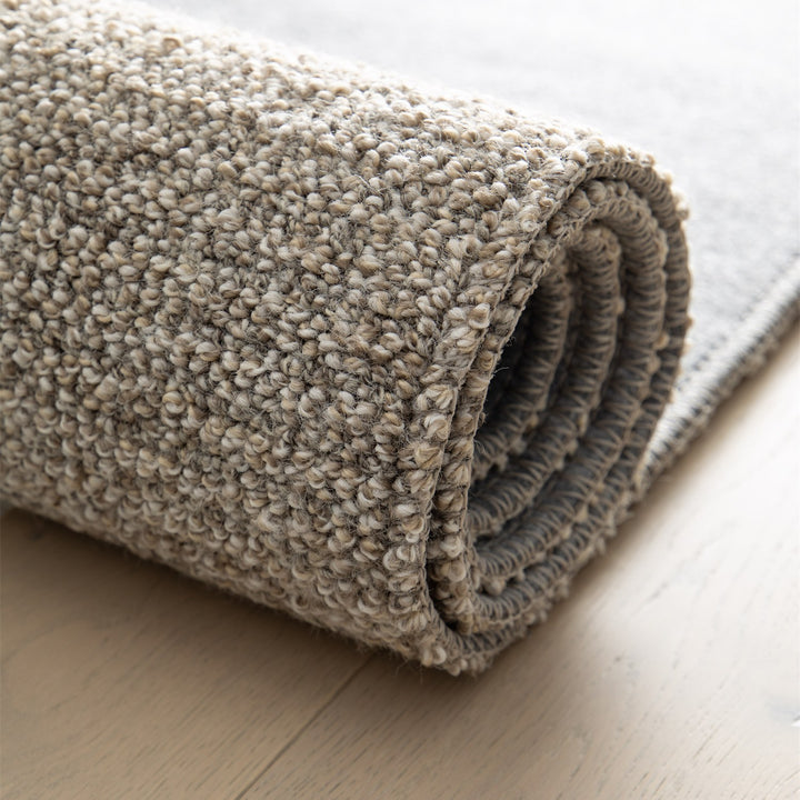 Dune Boucle greige textured rug, rolled up | The Rugs