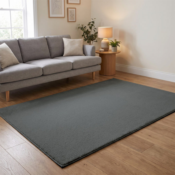 Washmellow grey washable rug in a living room with a grey sofa and oak floor | The Rugs