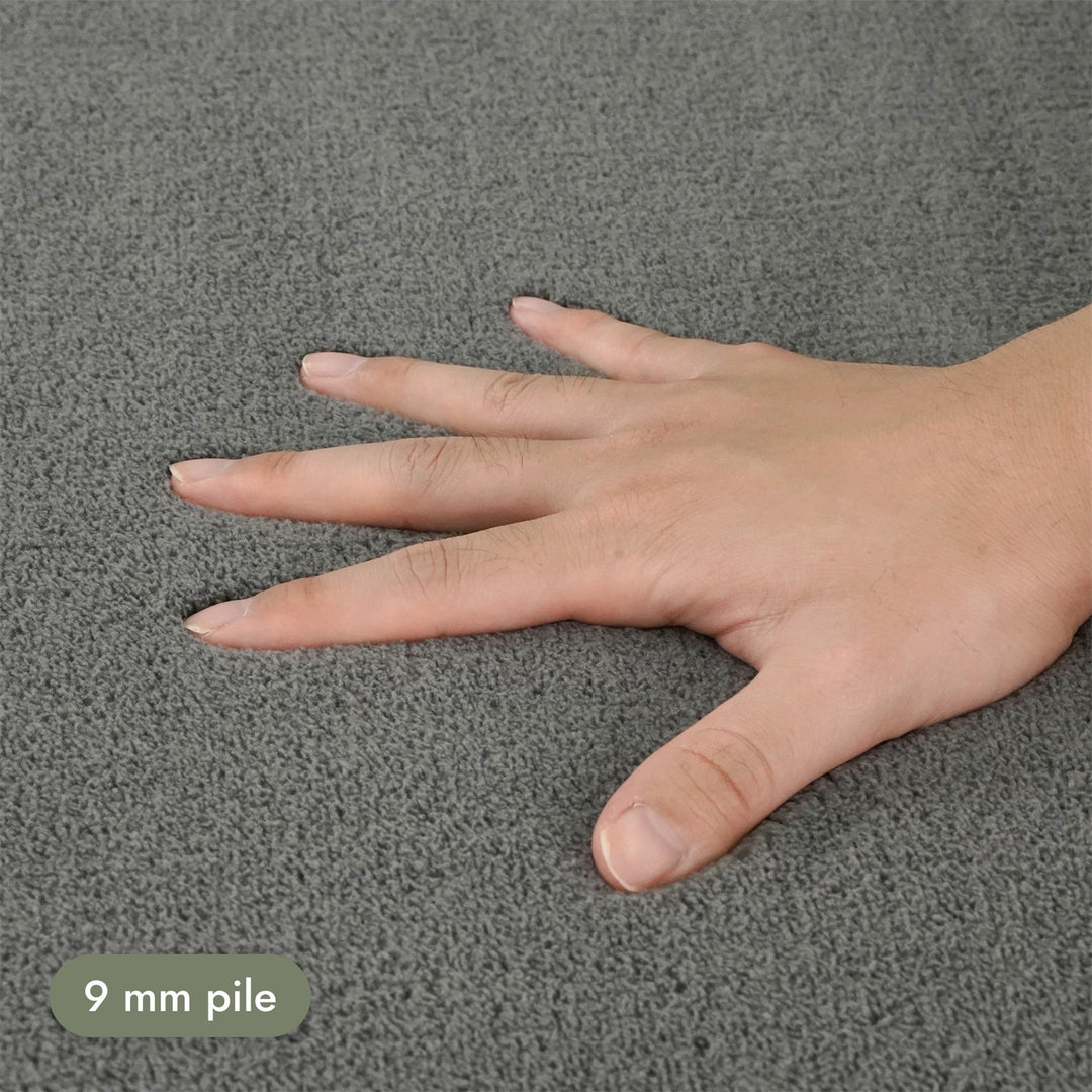 Washmellow grey washable rug, close-up of the soft 9mm pile under a hand | The Rugs