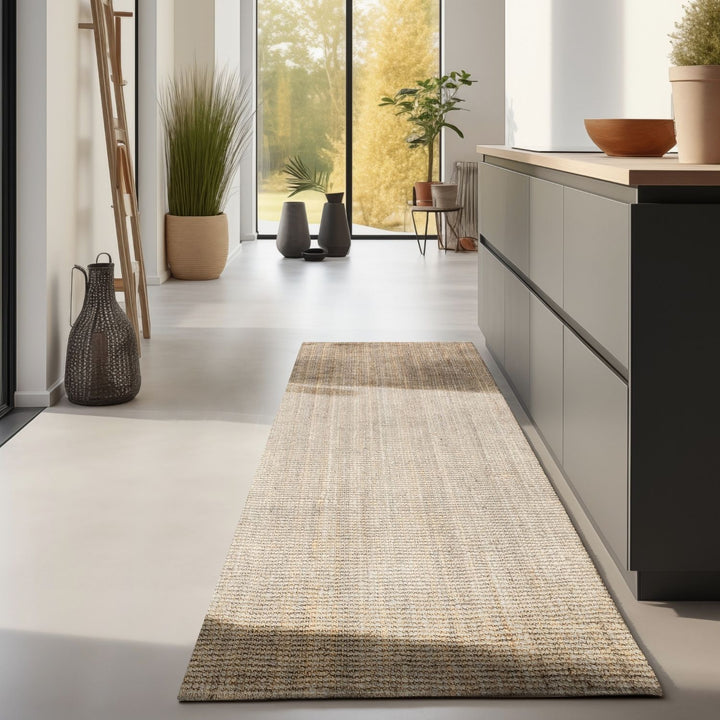 Long rectangular rug on a light gray floor with a kitchen and window in the background