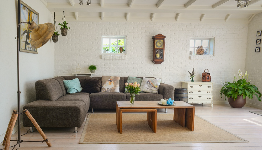 Living room with a gray sectional sofa, wooden coffee table, and decorative items.