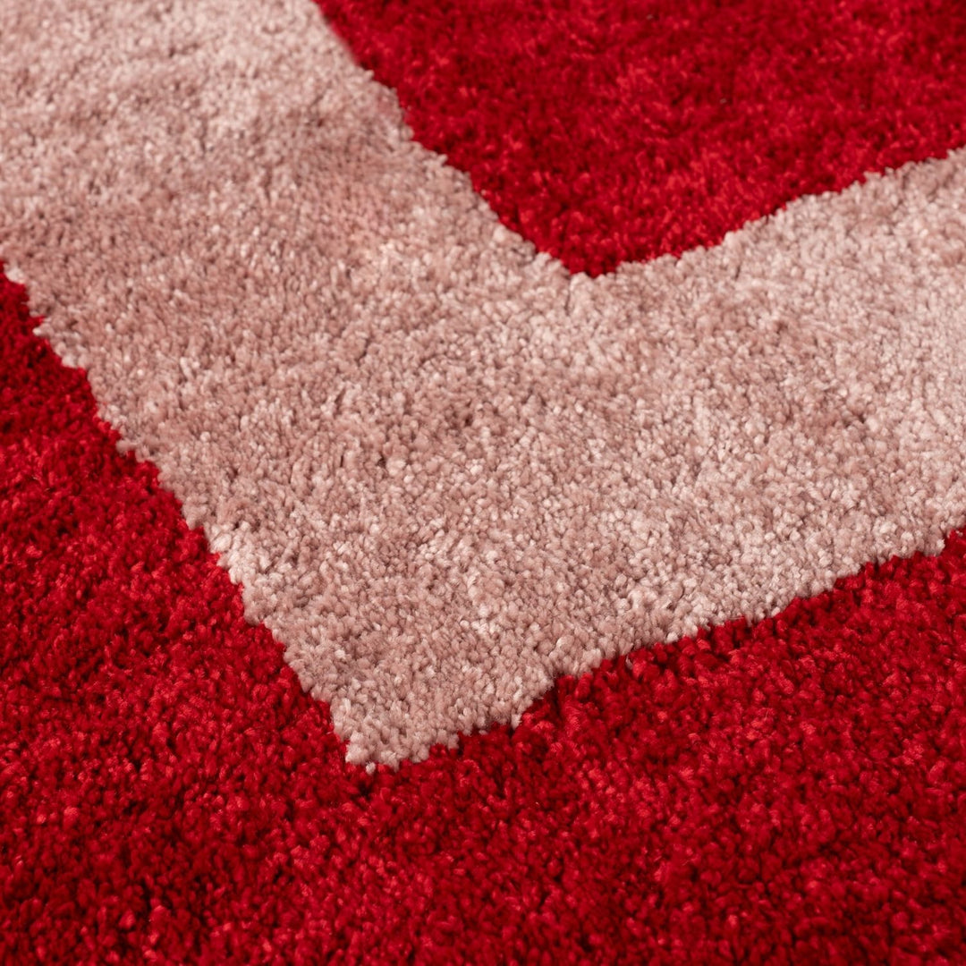 Close-up of a red and beige chevron-patterned rug