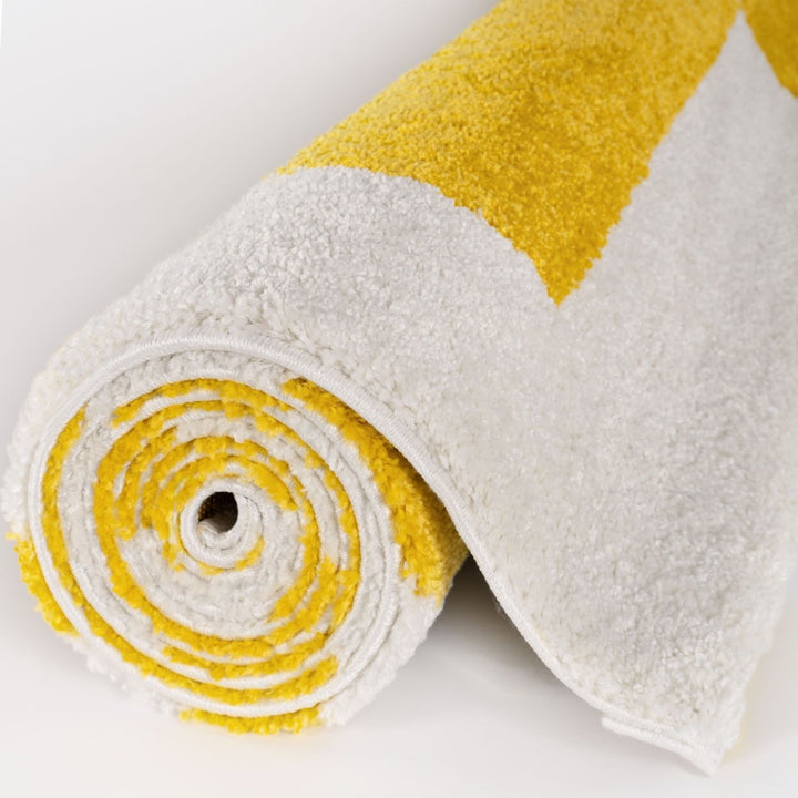 Roll of white and yellow fabric on a light gray background