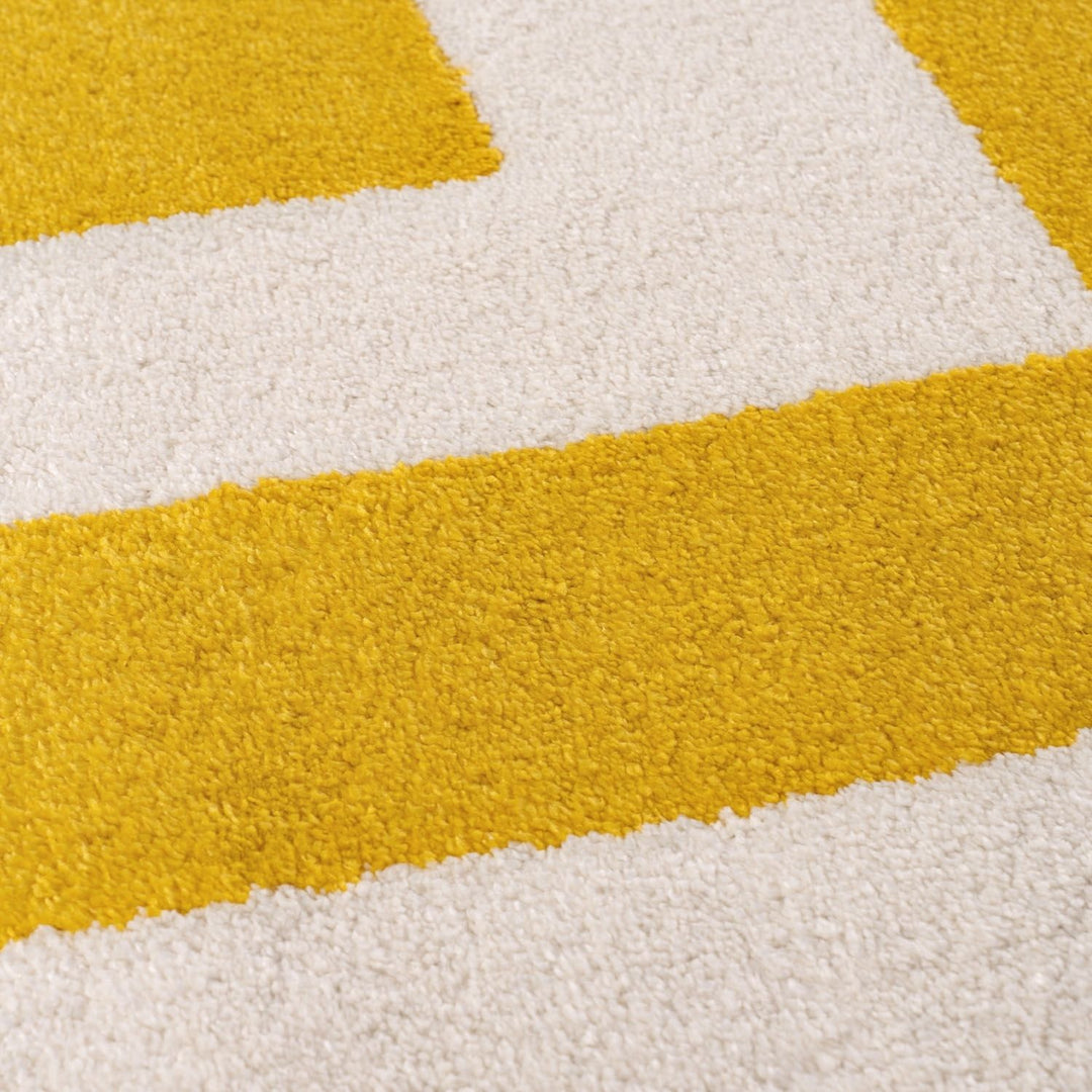 Close-up of a textured yellow and white rug with geometric pattern