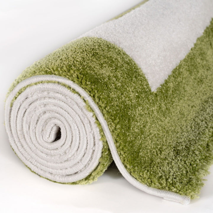 Green and gray textured rug rolled up on a white background