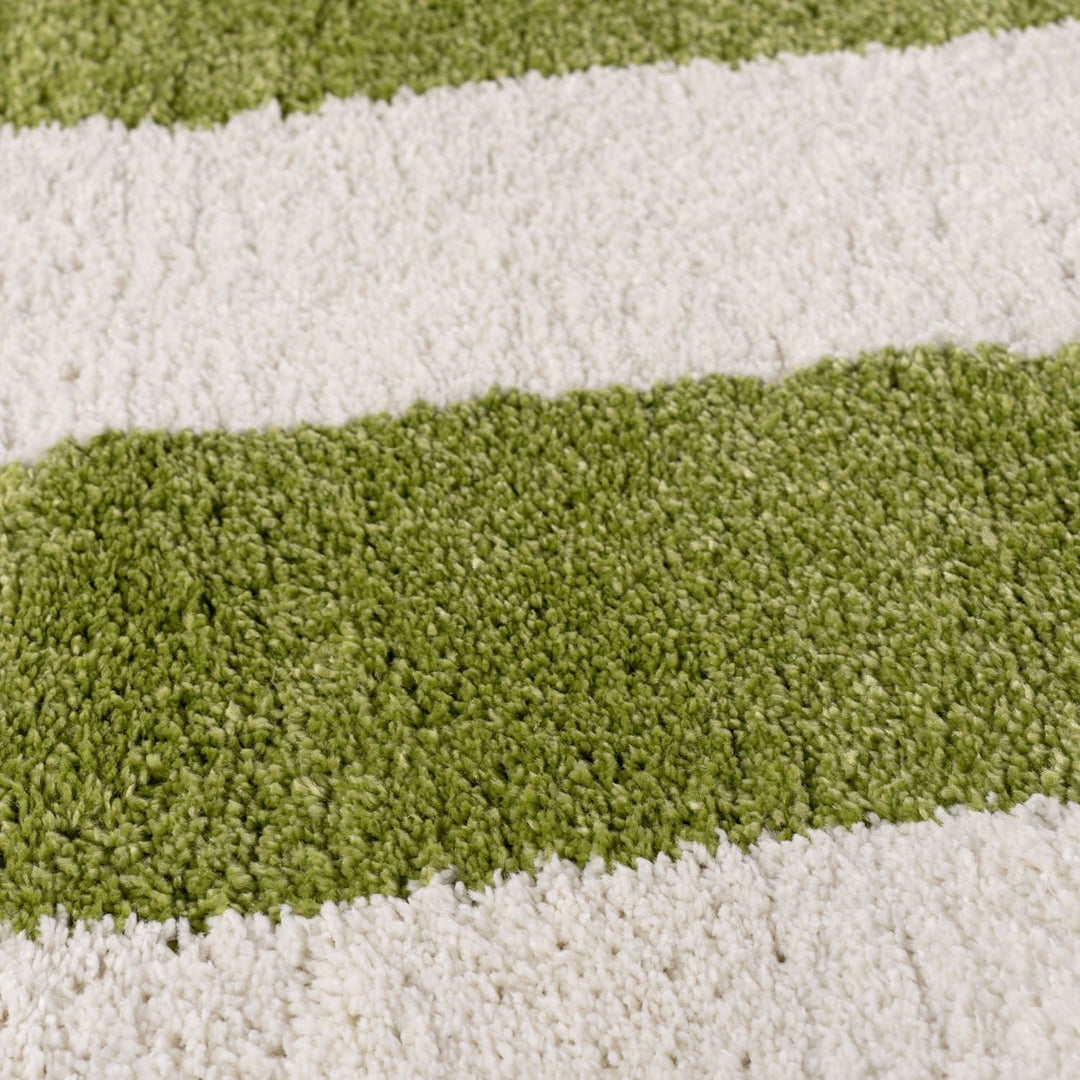 Close-up of a striped rug with green and white stripes.