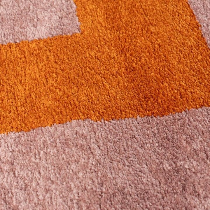 Close-up of a textured orange and pink rug