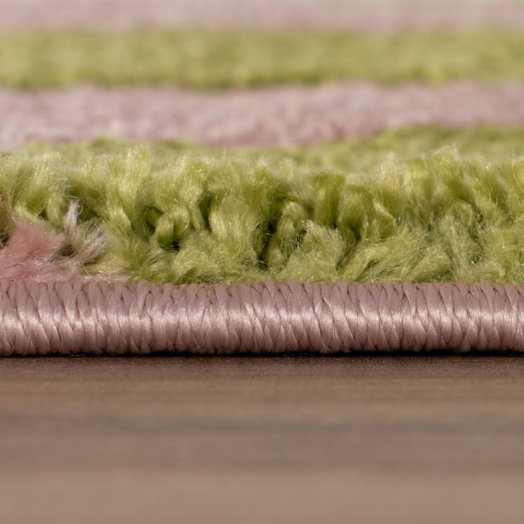Close-up of a green and pink textured fabric border