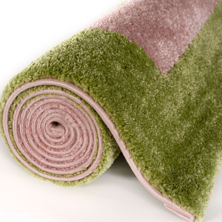 Roll of pink and green textured fabric on a white background