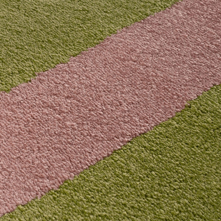 Close-up of a green and pink striped rug