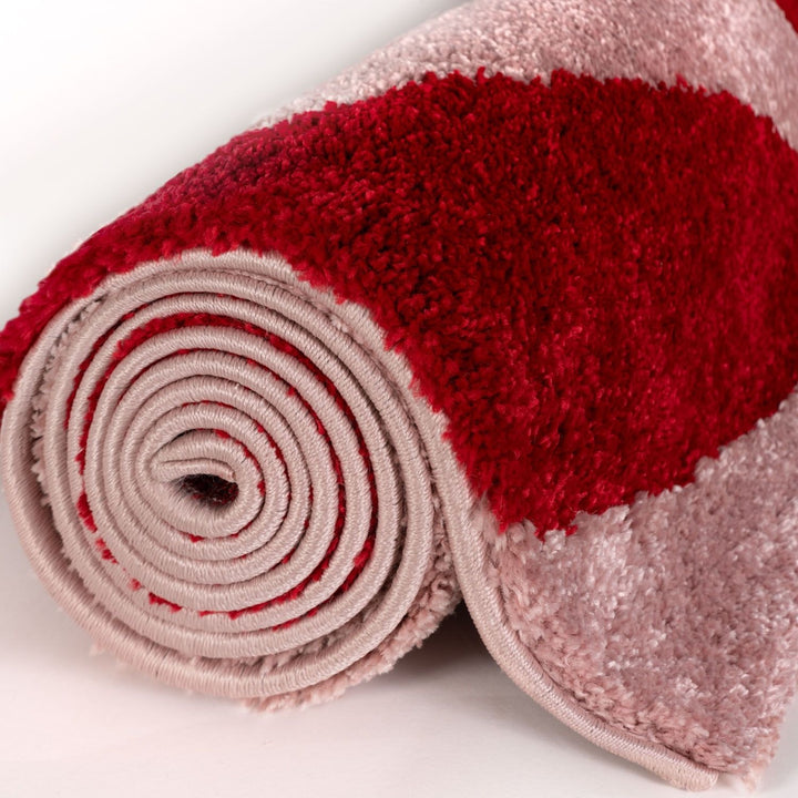 Roll of red and beige textured fabric on a white background
