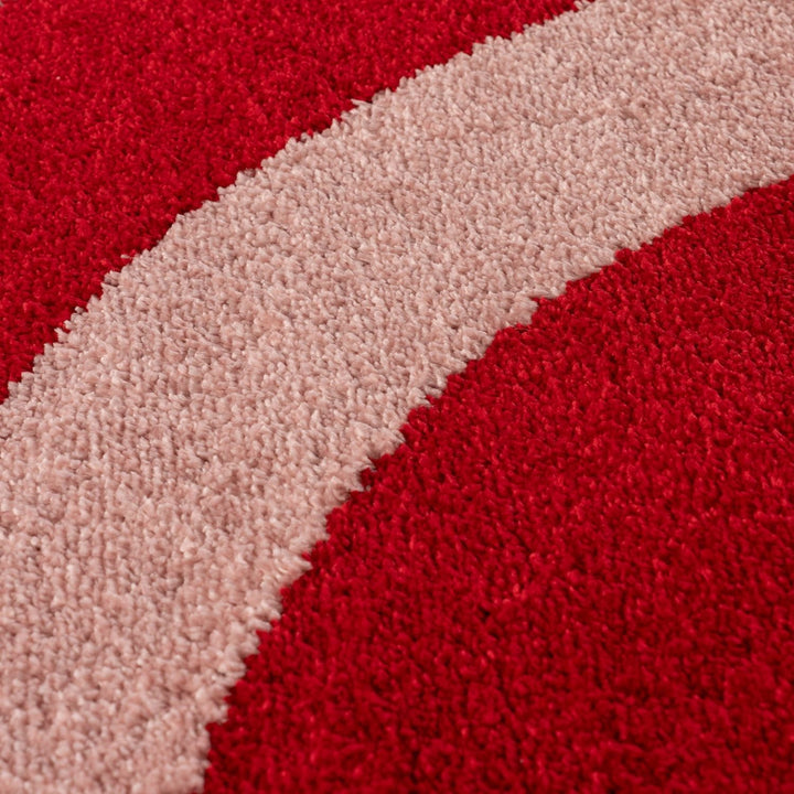 Close-up of red and pink textured fabric swatches.