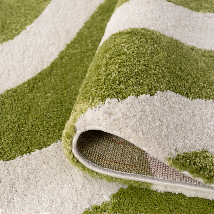 Close-up of a green and white striped rug with a textured surface.