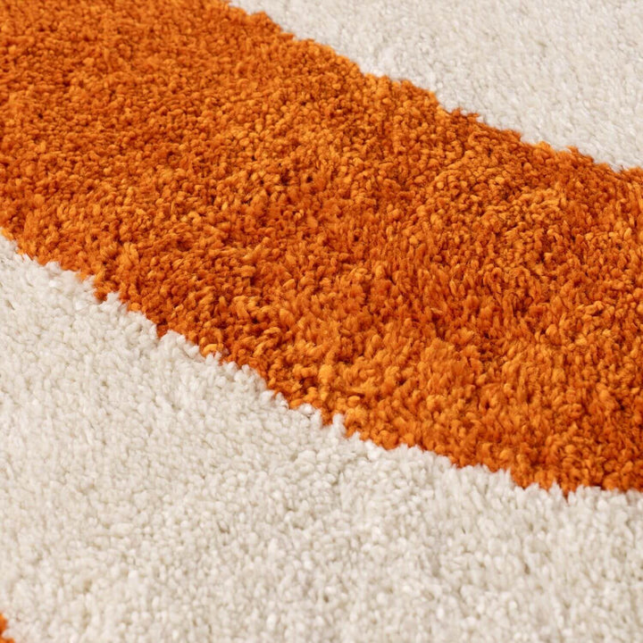 Close-up of a textured orange and white rug