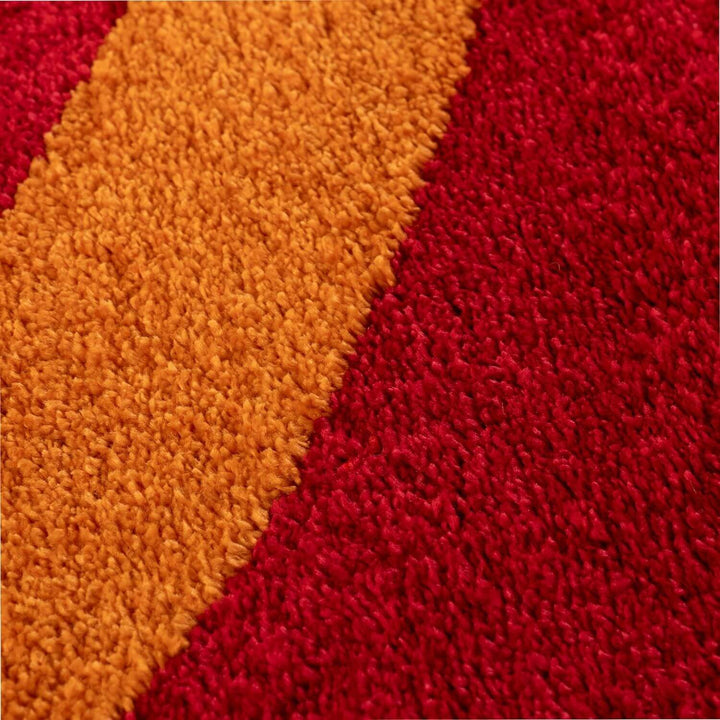Close-up of a textured red and orange fabric surface