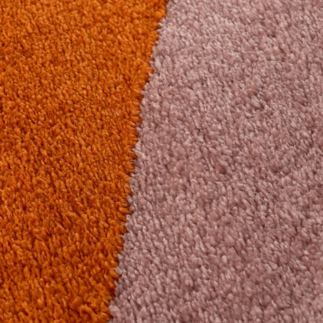 Close-up of orange and pink textured carpet