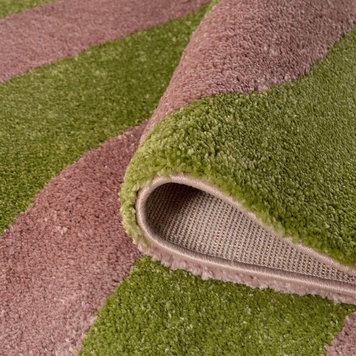 Close-up of a green and brown striped rug with a textured surface.