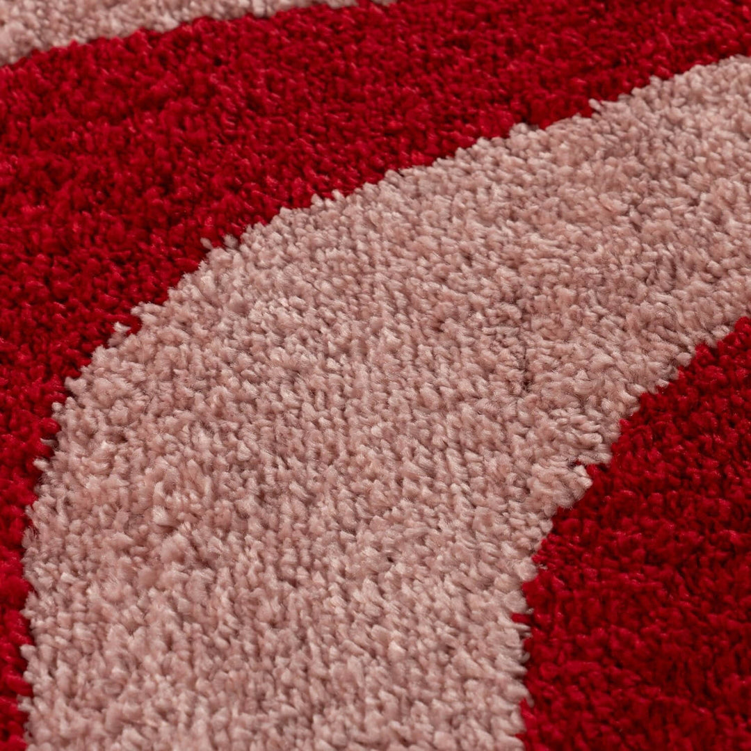 Close-up of a red and beige textured rug corner